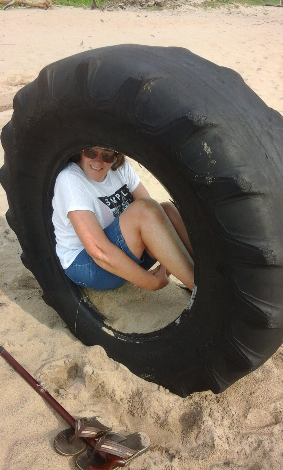 Me, at Mtwalume Beach, seeking shelter against the sun in the discarded tyre of a bulldozer