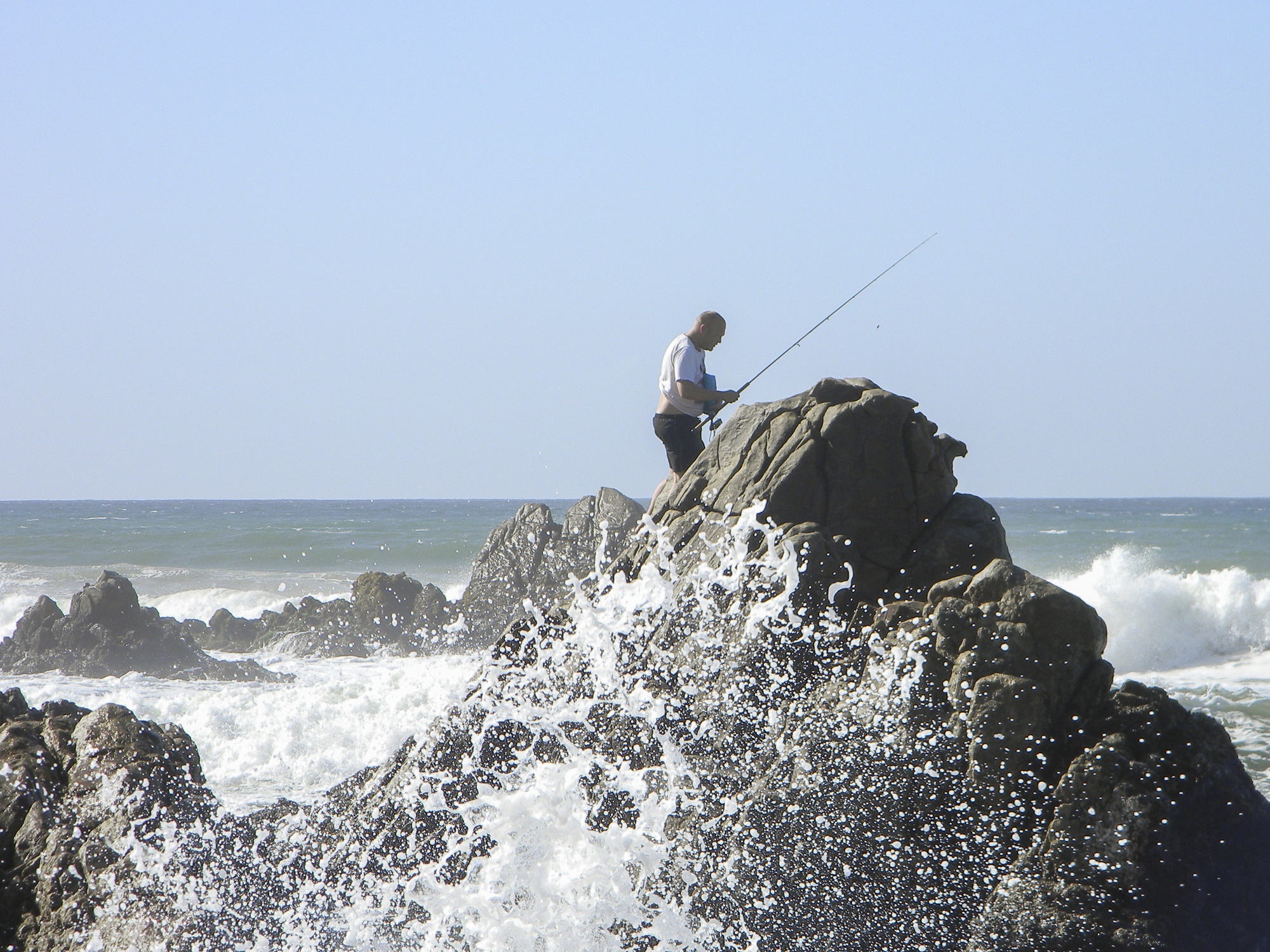 Enjoying the thrill of the breaking waves at high tide. Fishing rocks!