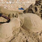 The artist sculpting a sand art hippopotamus on St Michaels on Sea Beach in KwaZulu-Natal