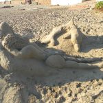 Lady and dolphin sand art on Scottburgh Beach KwaZulu-Natal