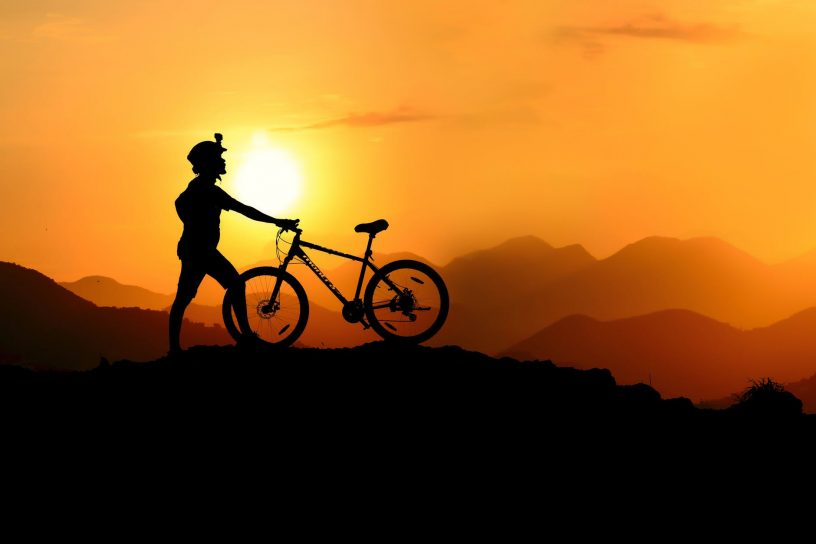 silhouette photography of biker on top of hill